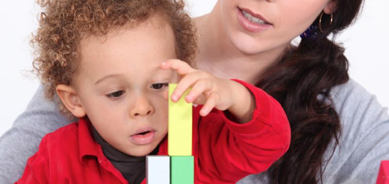 Boy with woman using building blocks