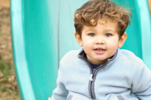 Cute little boy on a slide at the park